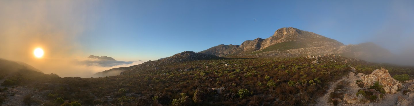 Misty sunset on the cliffs of Constantiaberg from Noordhoek Peak, Cape Town — meditation can feel like prolonging this sublime peaceful moment indefinitely